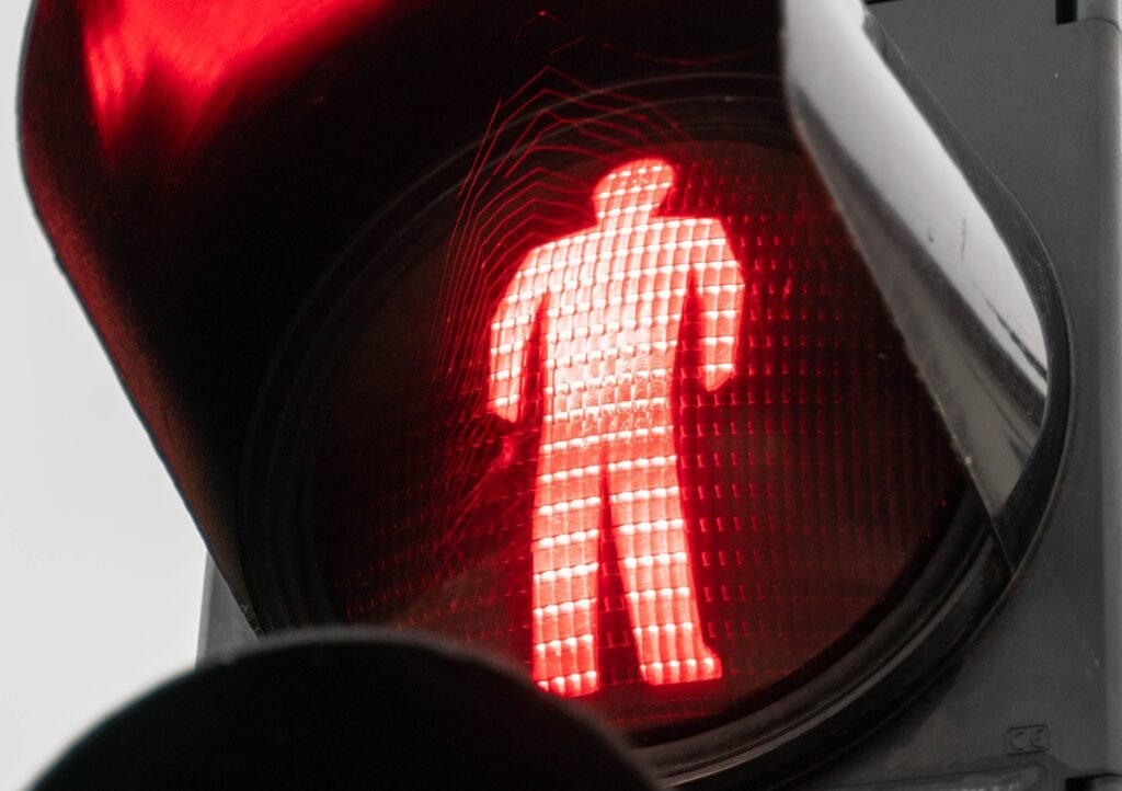 Detailed view of a red pedestrian crossing signal indicating stop.